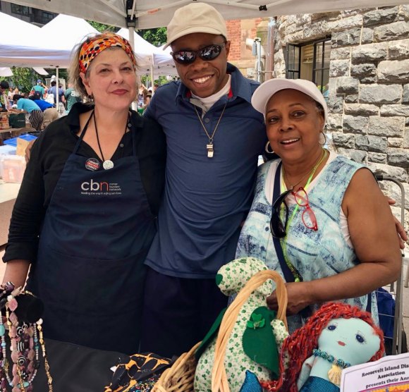 Roosevelt Island Day in Pictures, 2019 CBN/RI Senior Center Director Lisa Fernandez (L) and Mary Coleman (R) drew a youthful admirer.